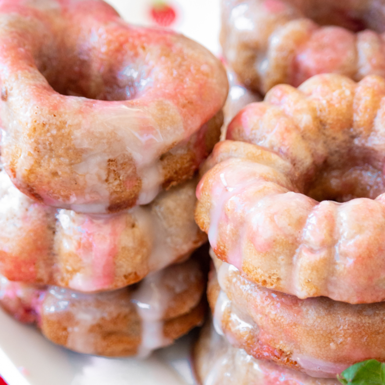 Overhead view of homemade air fryer strawberry donuts on a wire rack