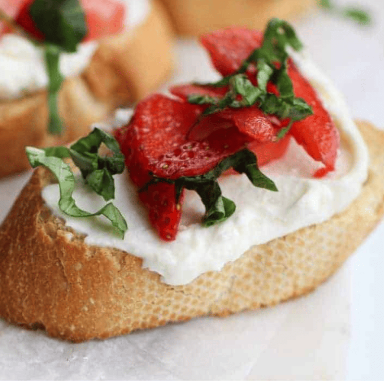 Finished strawberry mascarpone bruschetta arranged on a serving board for a party
