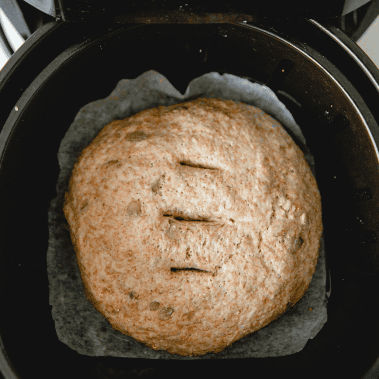 Shaped whole wheat dough on parchment paper inside the air fryer basket