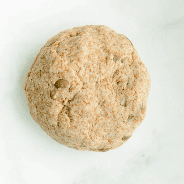 Kneaded whole wheat dough with sunflower seeds evenly distributed throughout