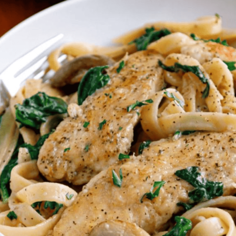 Delicious Olive Garden Copycat Chicken Marsala Fettuccine served on a plate, featuring tender chicken, creamy Marsala sauce, sautéed mushrooms, and garnished with fresh parsley and grated Parmesan cheese.