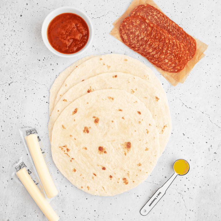 Ingredients for Easy Air Fryer Pizza Roll Ups, including tortillas mozzarella cheese, pepperoni slices, Italian seasoning, and marinara sauce."