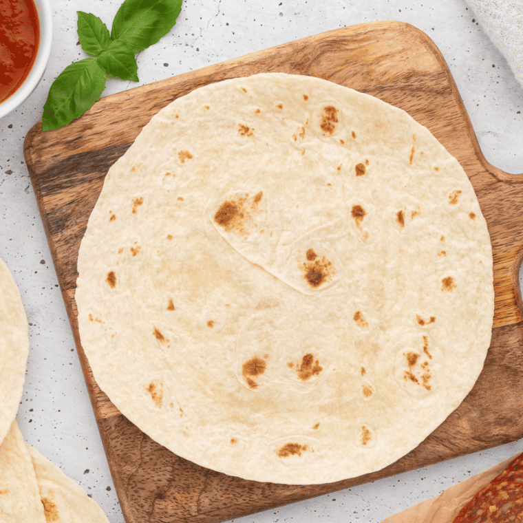 Warm the tortilla in the microwave.