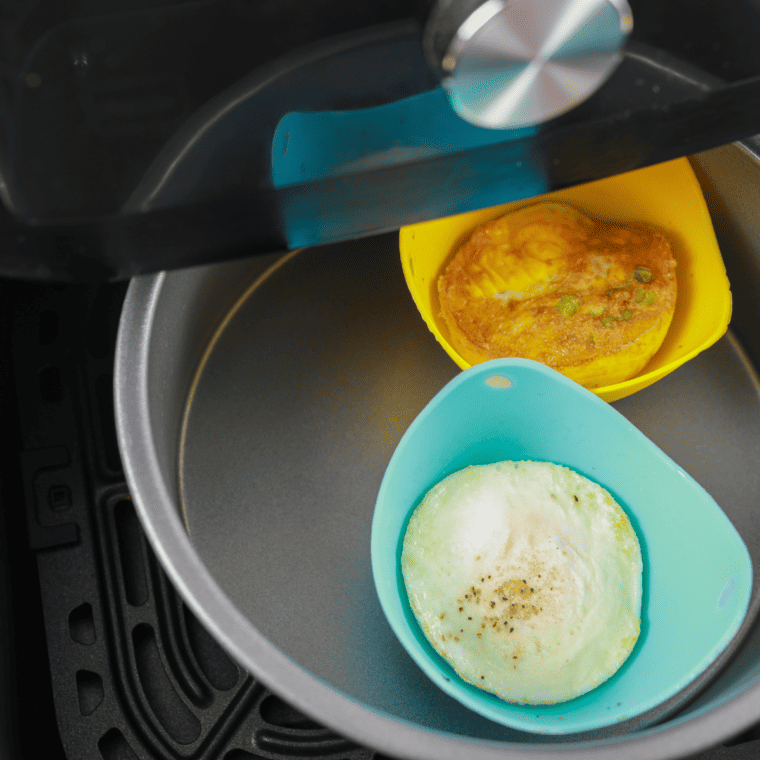 Baked eggs in air fryer ramekin cooked until perfectly set with soft yolks for easy low-carb keto breakfast recipe