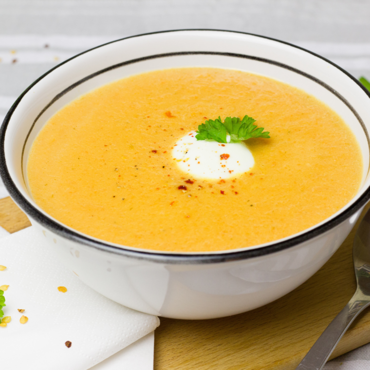 A steaming bowl of Outback Steakhouse Walkabout Soup garnished with melted cheese and crispy croutons