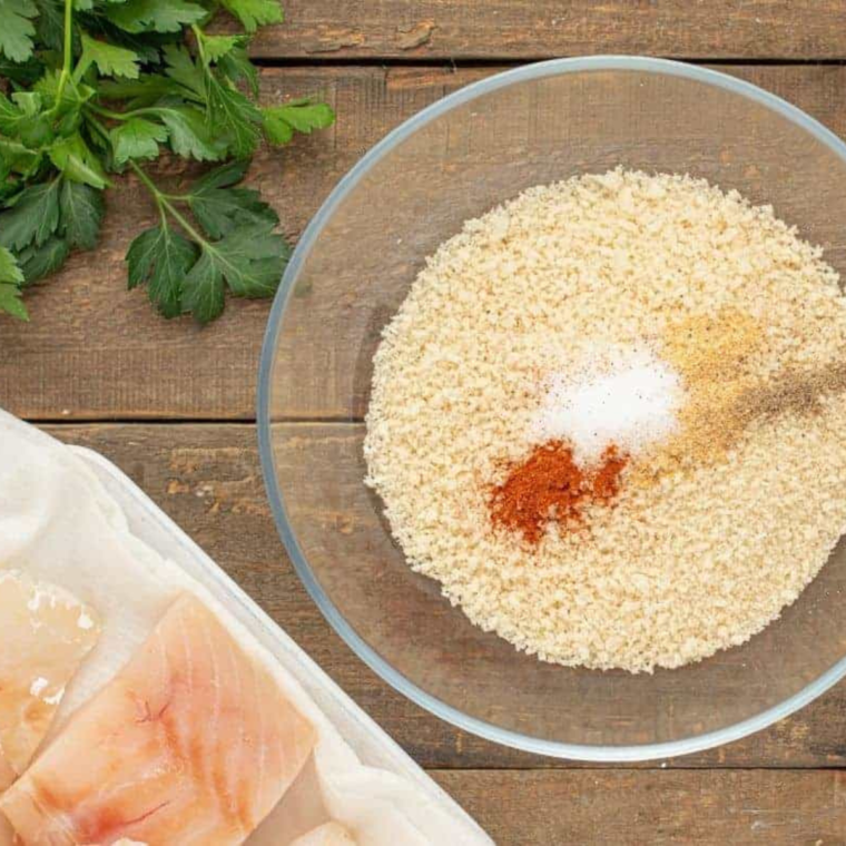 Patting cod fillets dry with paper towels and seasoning both sides with salt and pepper.