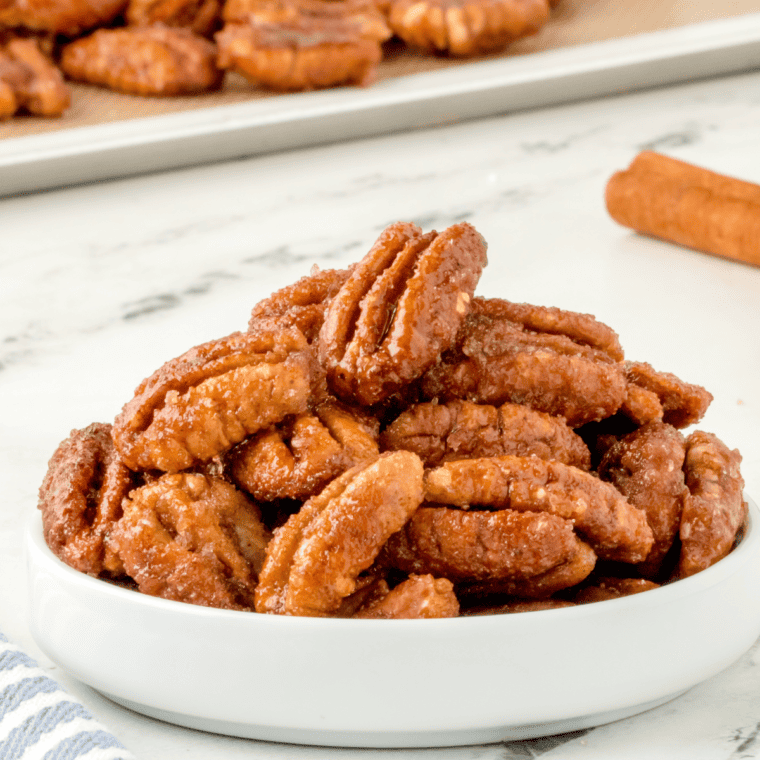 Roasted pecans in the air fryer seasoned three ways—sweet, salty, and spicy—cooling on a tray.