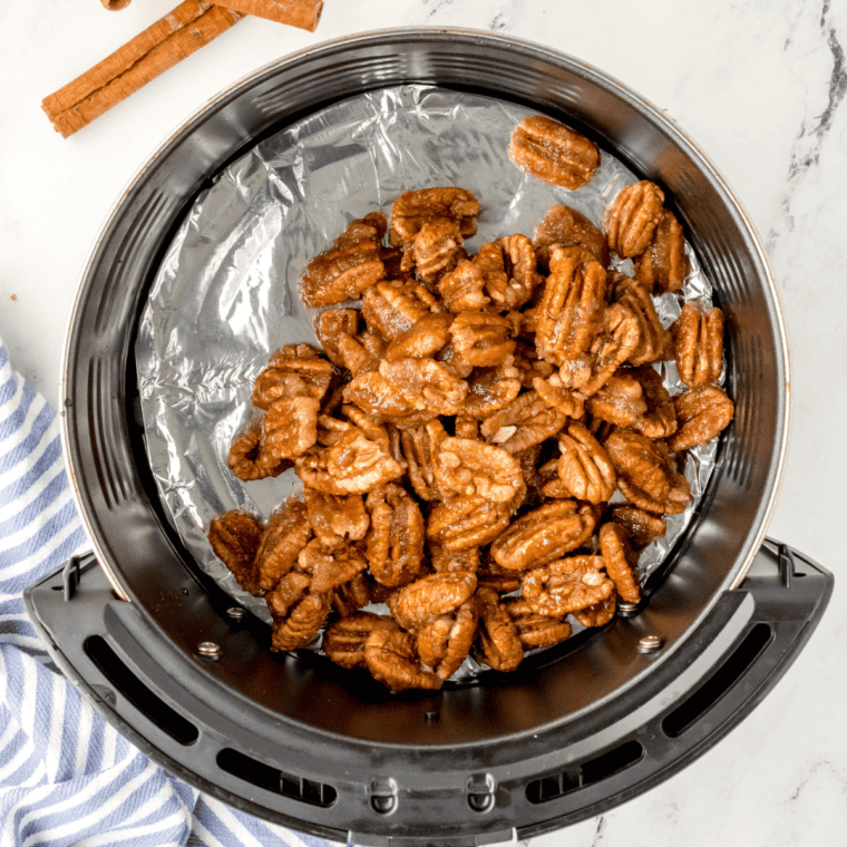 Place the seasoned pecans in the air fryer basket.