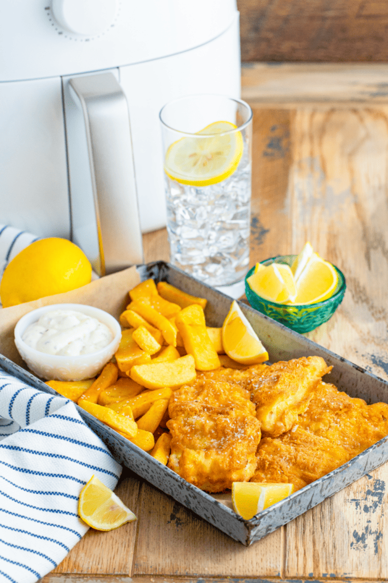 Crispy air-fried fish fillets with golden fries and a side of homemade tartar sauce.