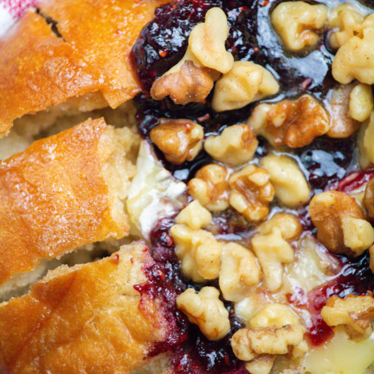 "Air fryer pull-apart bread with melted Brie and fresh raspberries on a serving plate"