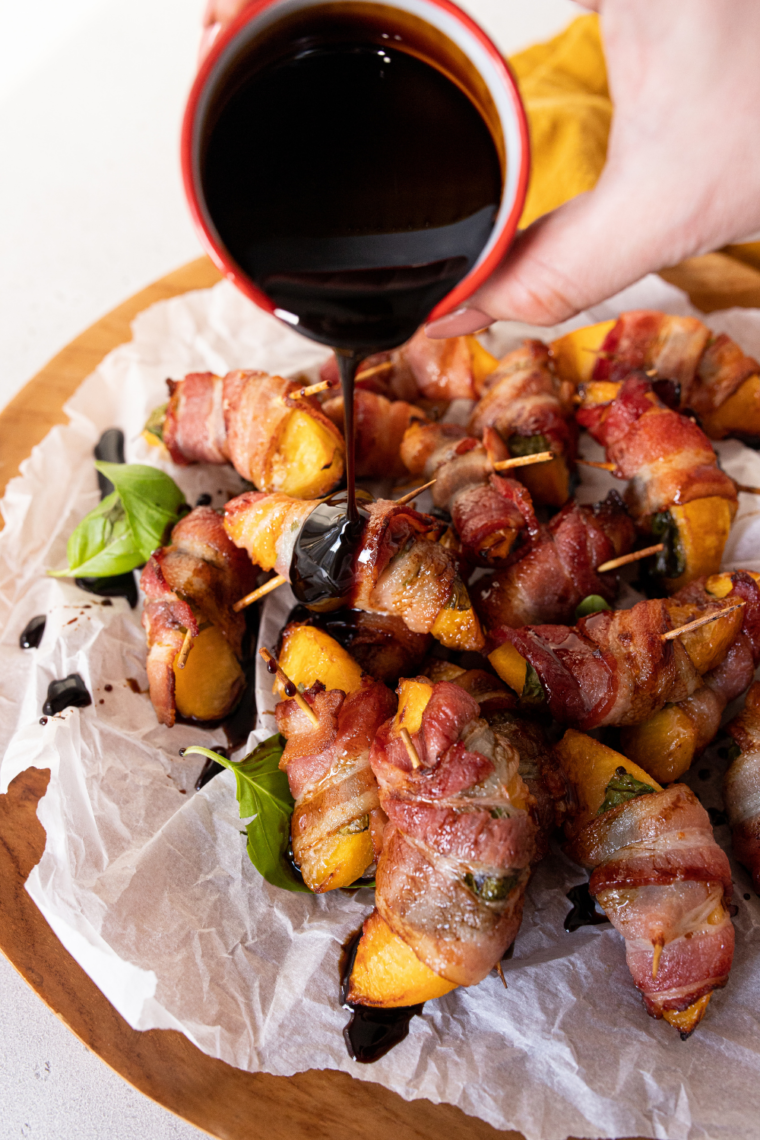 Air Fryer Bacon Wrapped Peaches with crispy bacon and juicy peaches, served as a sweet and savory appetizer.