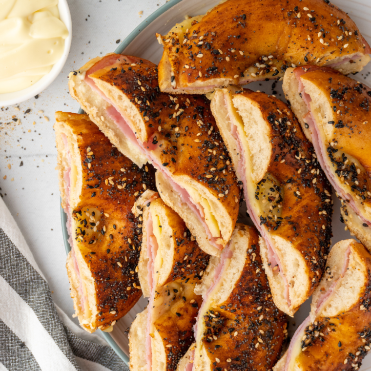 Close-up of air fryer bagel breakfast sliders, showing the melted cheese and hearty fillings
