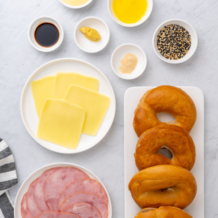 Ingredients for Air Fryer Bagel Breakfast Sliders: bagels, eggs, cheese, bacon or sausage, and any additional toppings or condiments