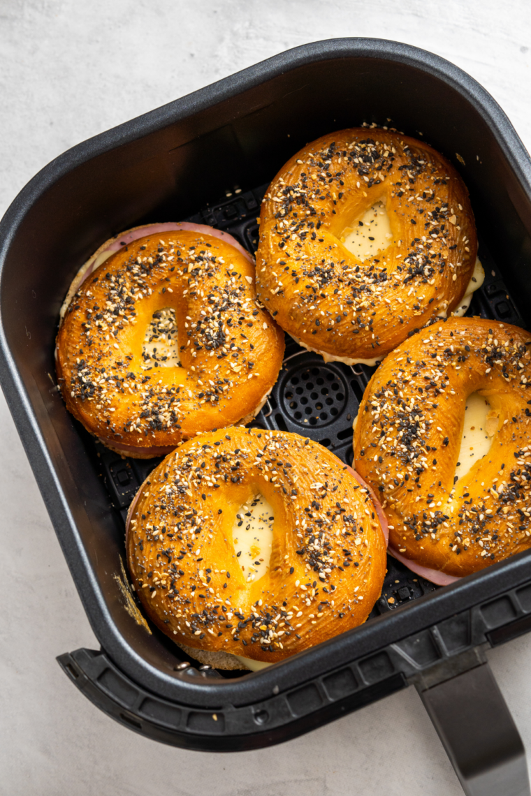 Air fryer bagel sliders stacked on a plate, ready for a delicious breakfast