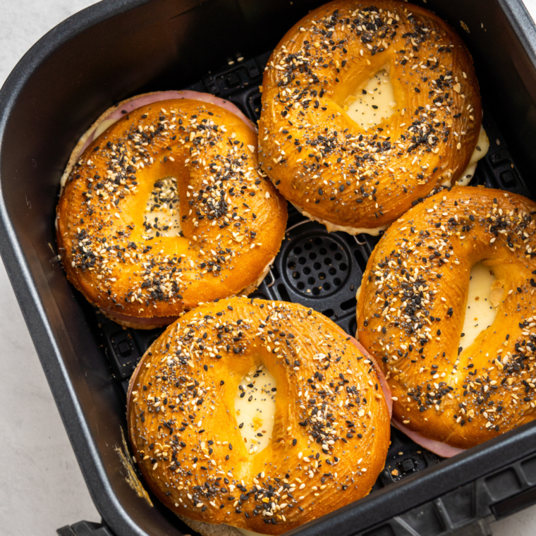 Air frying the assembled bagel breakfast sliders until the cheese is melted and everything is heated through