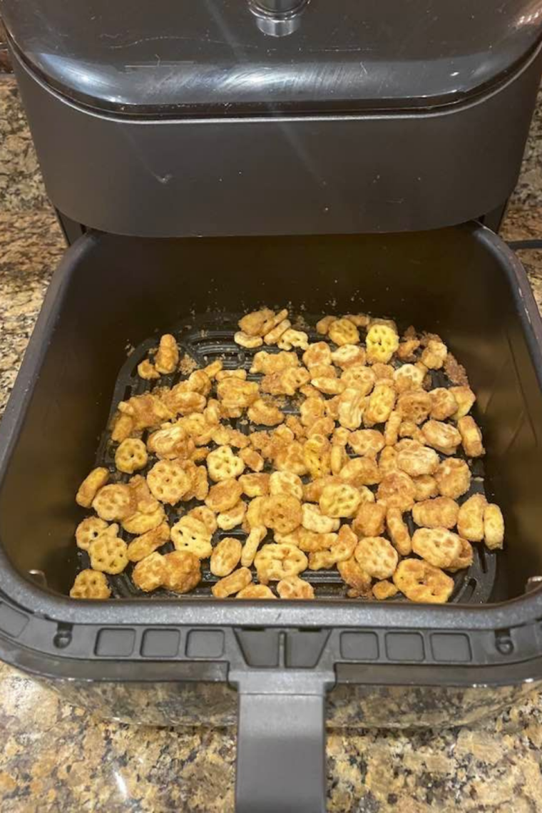 Air Fryer Churro Honeycomb Snack Mix crisping in the air fryer basket