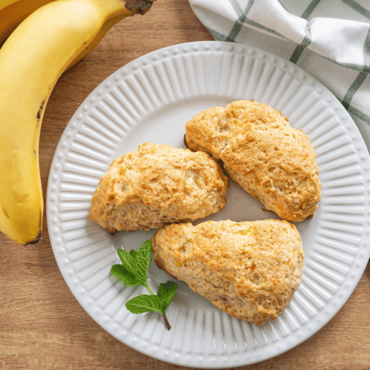 Freshly made Air Fryer Banana Scones topped with a sweet icing glaze, perfect for breakfast or a snack.