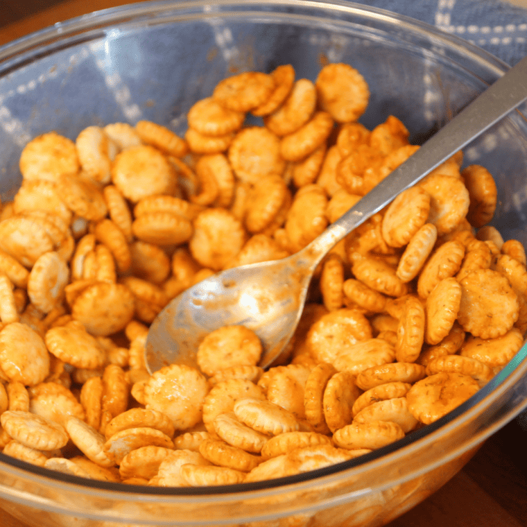 "Tossing oyster crackers in seasoning mixture until evenly coated"