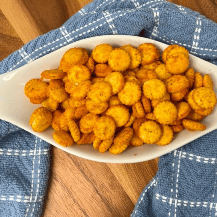 Golden Air Fryer Buffalo Oyster Crackers coated in spicy buffalo seasoning
