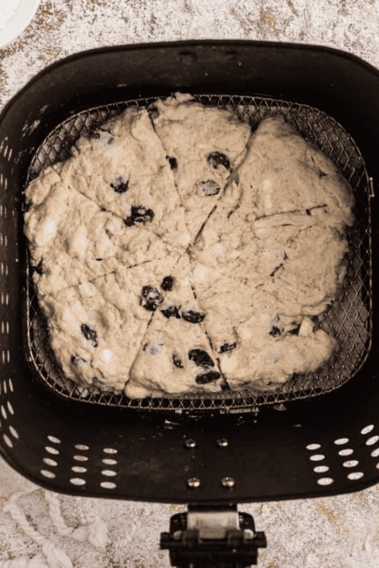 Freshly baked Air Fryer Cinnamon Raisin Scones on a plate, golden and fluffy.