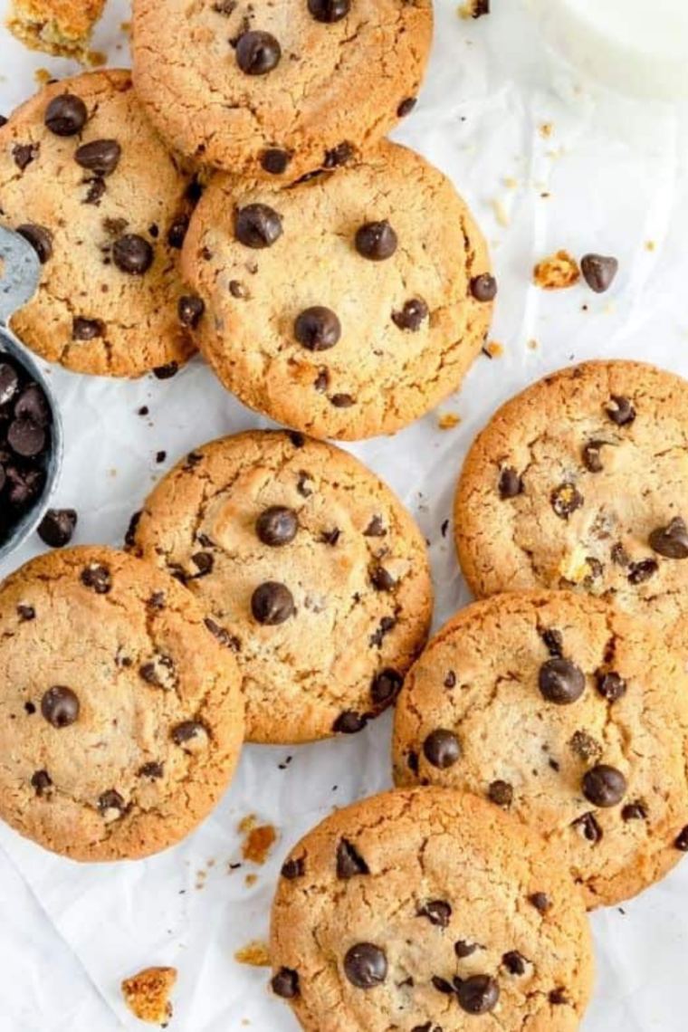Air fryer DoubleTree copycat cookies stacked on a plate, with melted chocolate chips and crunchy walnuts.