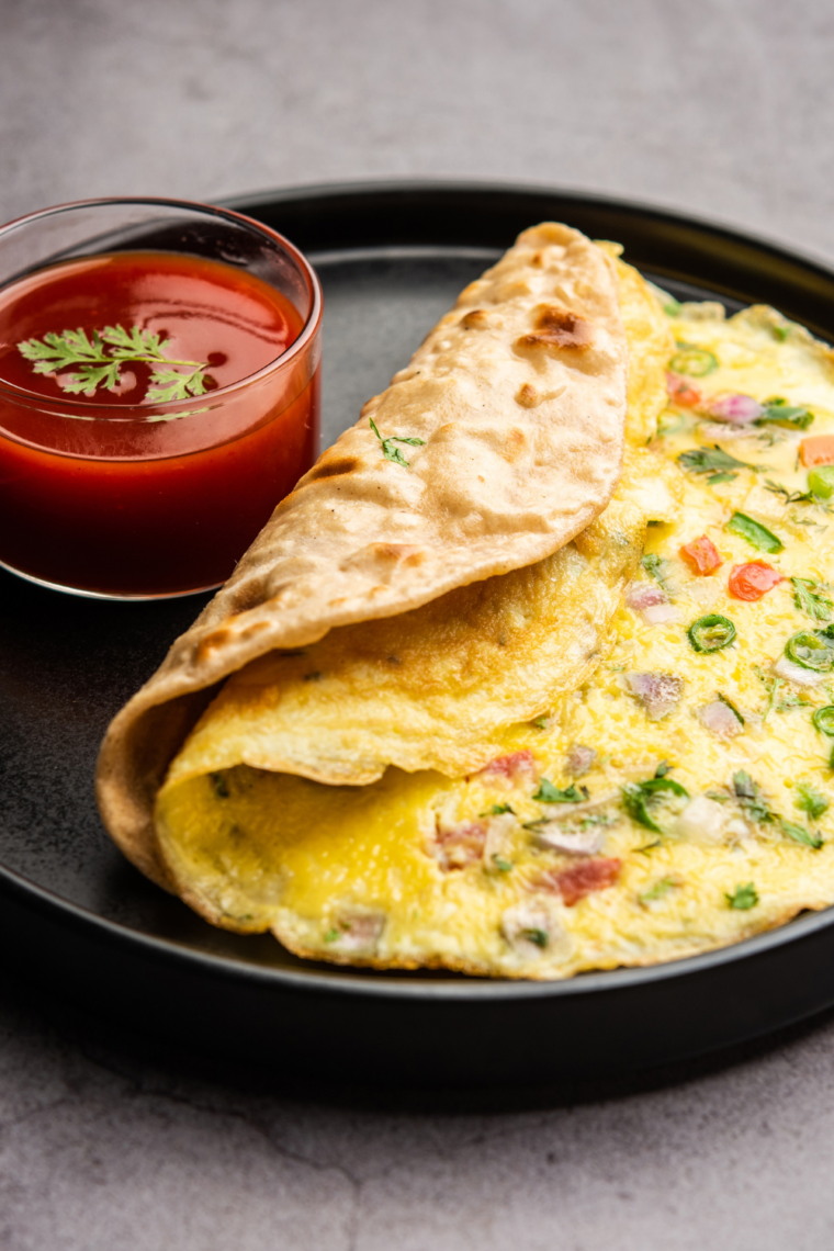 Air fryer ham and cheese omelette sliced open with melted cheese center