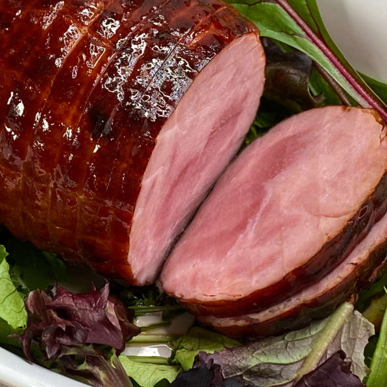 Air Fryer Honey Glazed Baked Ham with a golden, caramelized glaze, served on a platter with garnishes.