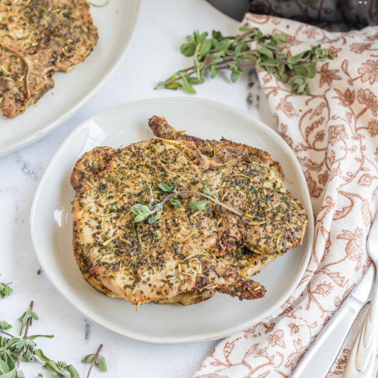 Air Fryer Italian Pork Chops, golden and crispy, seasoned with Italian herbs, ready to serve for a tasty meal.