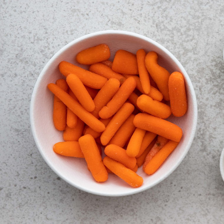 Ingredients for Air Fryer Ranch Carrots - "Ingredients laid out for making Air Fryer Ranch Carrots, including baby carrots and ranch seasoning."