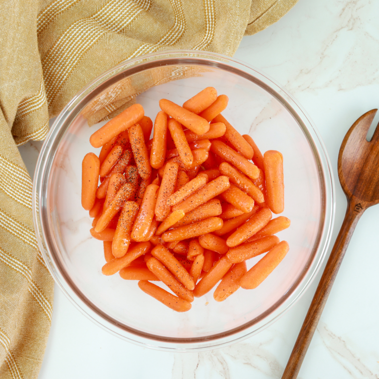 Mixing Ranch Seasoning with Carrots: A picture of a bowl with carrots being mixed with ranch seasoning.