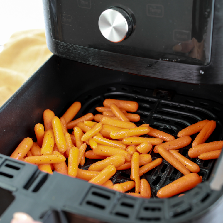 Placing Carrots in Air Fryer Basket: An image showing seasoned carrots arranged in the air fryer basket.