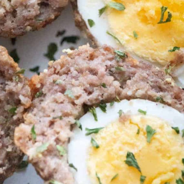 Plate of golden, crispy air fryer Scotch eggs ready to serve