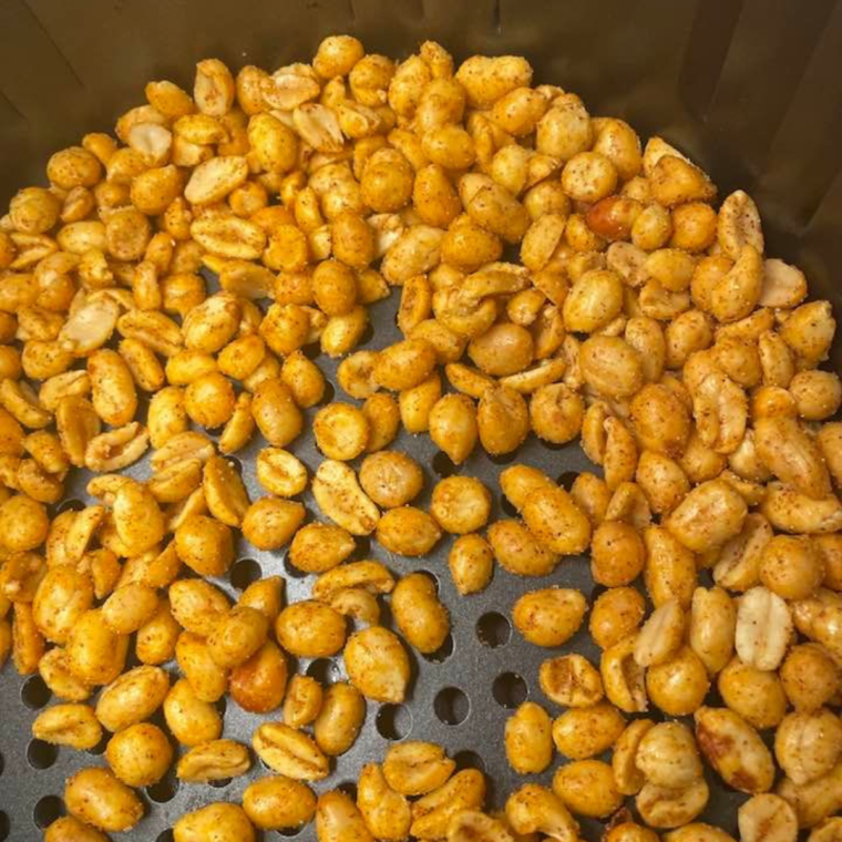 "Peanuts roasting in air fryer or oven to create Planters Heat Peanuts copycat."