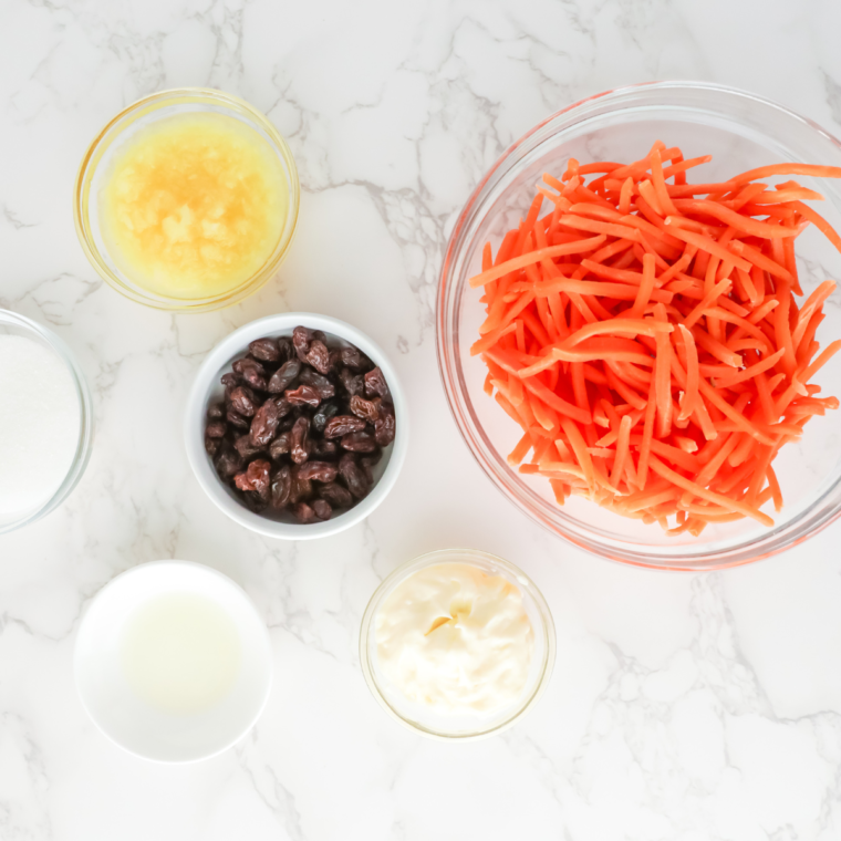 Copycat Chick Fil A Carrot Raisin Salad ingredients on table.