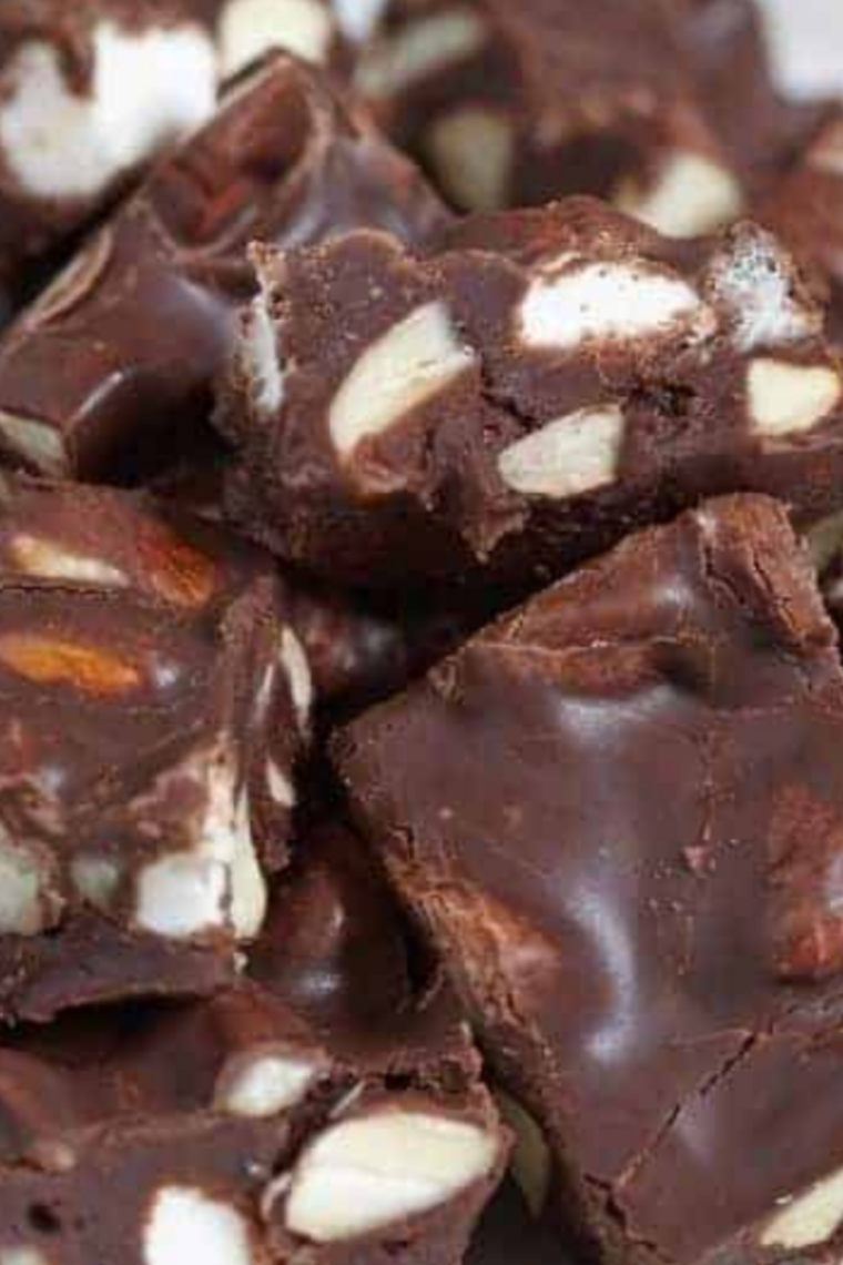 "An elegant serving dish filled with freshly made Instant Pot Rocky Road Fudge, garnished with extra marshmallows and nuts for a festive touch."

