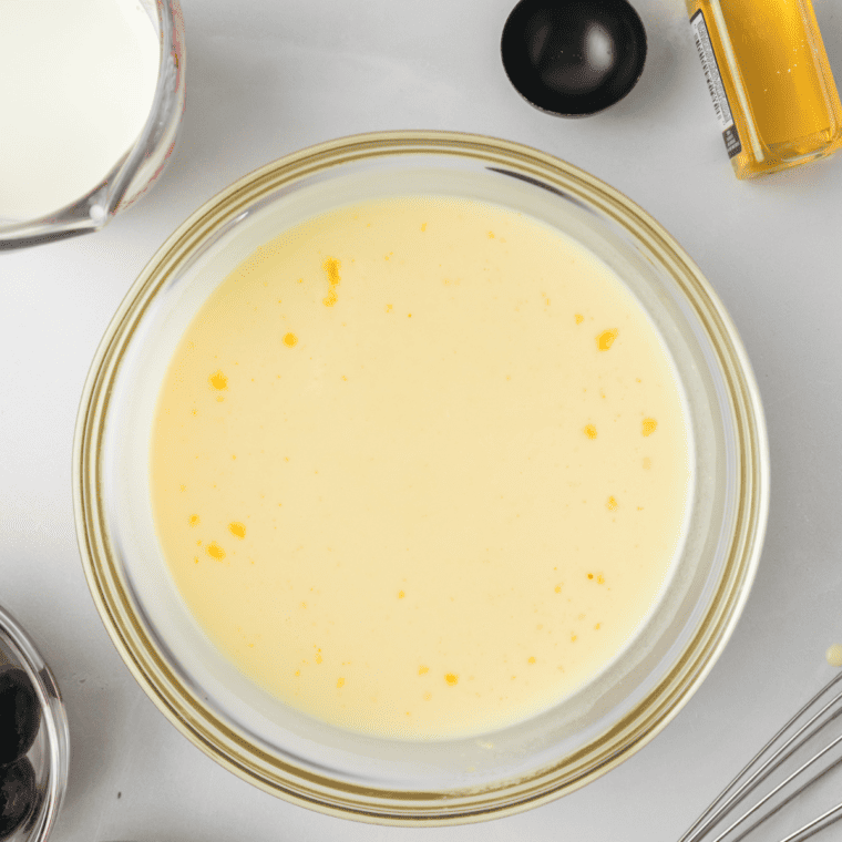 Whisking cream, milk, sugar, vanilla, and rum for Ninja Creami Cherry Garcia ice cream base