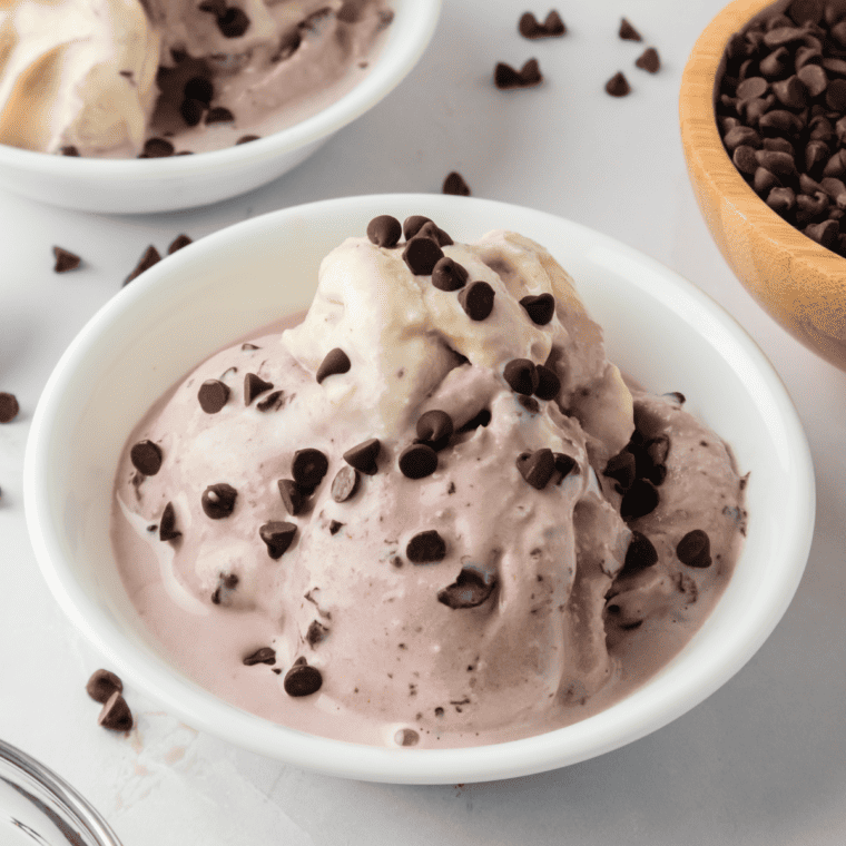 Cherry Garcia Ice Cream In Bowl on the kitchen counter, garnished with chocolate chips.