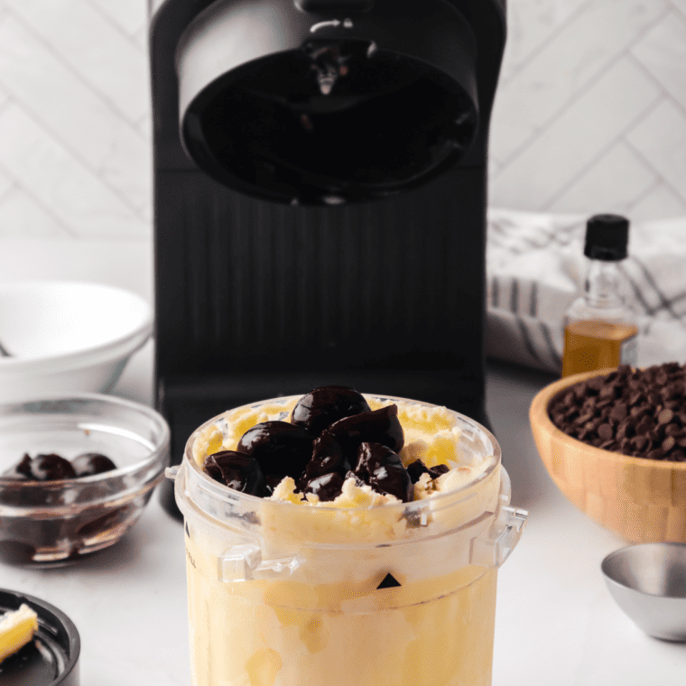 Ninja Creami machine processing frozen cherry chocolate ice cream base