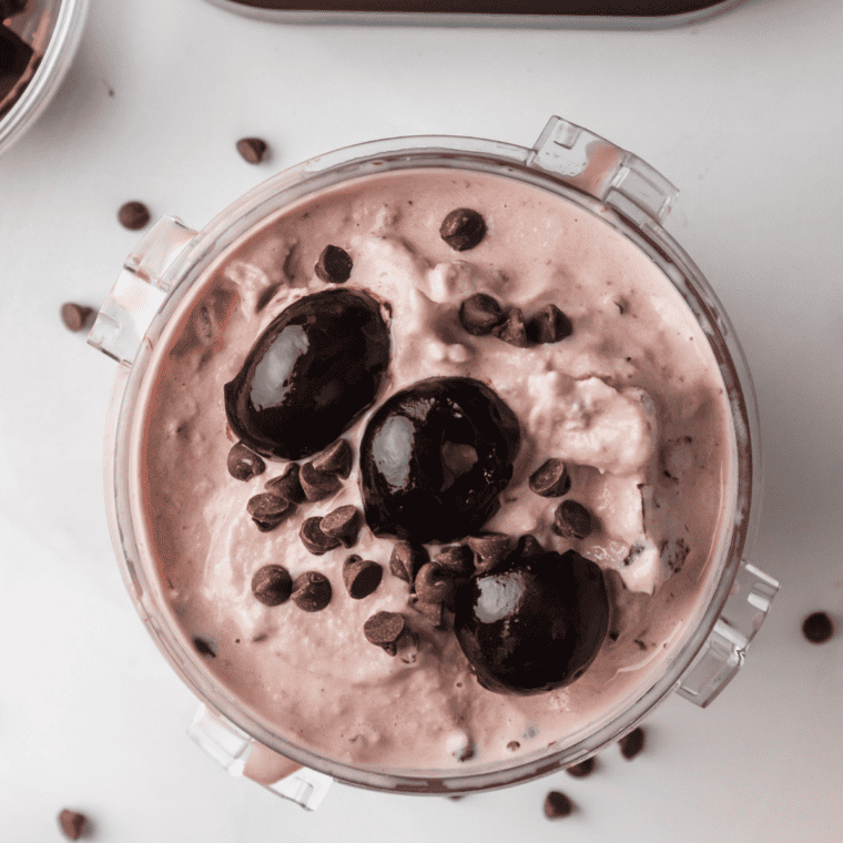 Bowl of Boozy Cherry Garcia Ice Cream with garnishes on top.