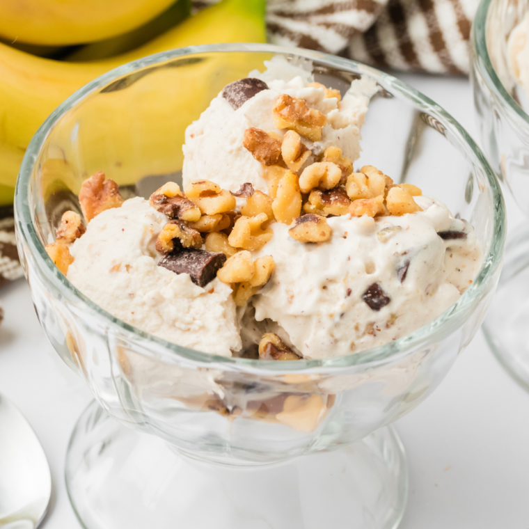 Bowl of homemade Ninja Creami Copycat Ben & Jerry’s Chunky Monkey ice cream with chocolate chunks and walnuts.