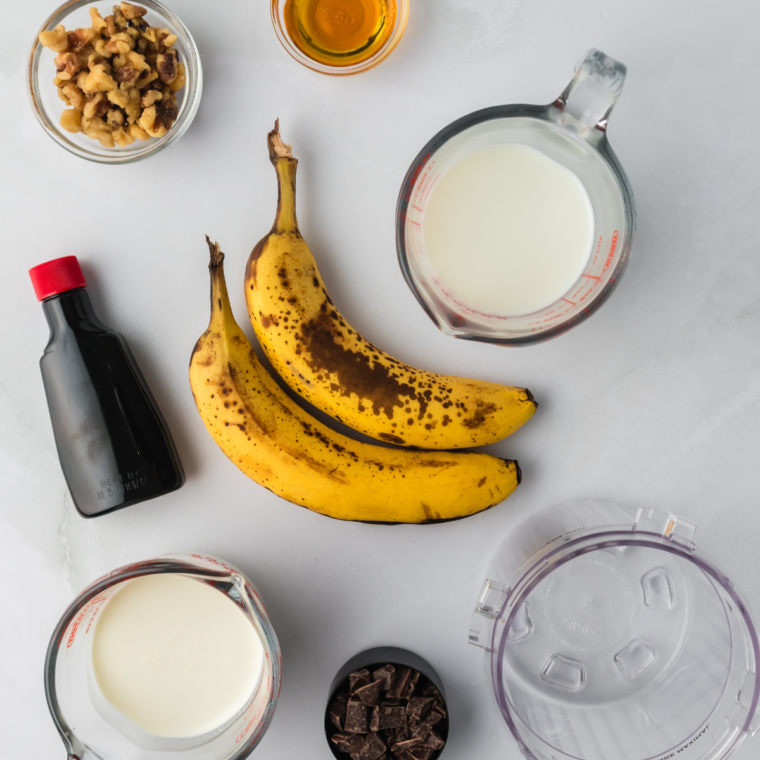 Ingredients needed for Ninja Creami Copycat Ben & Jerry's Chunky Monkey Ice Cream Recipe on kitchen table.