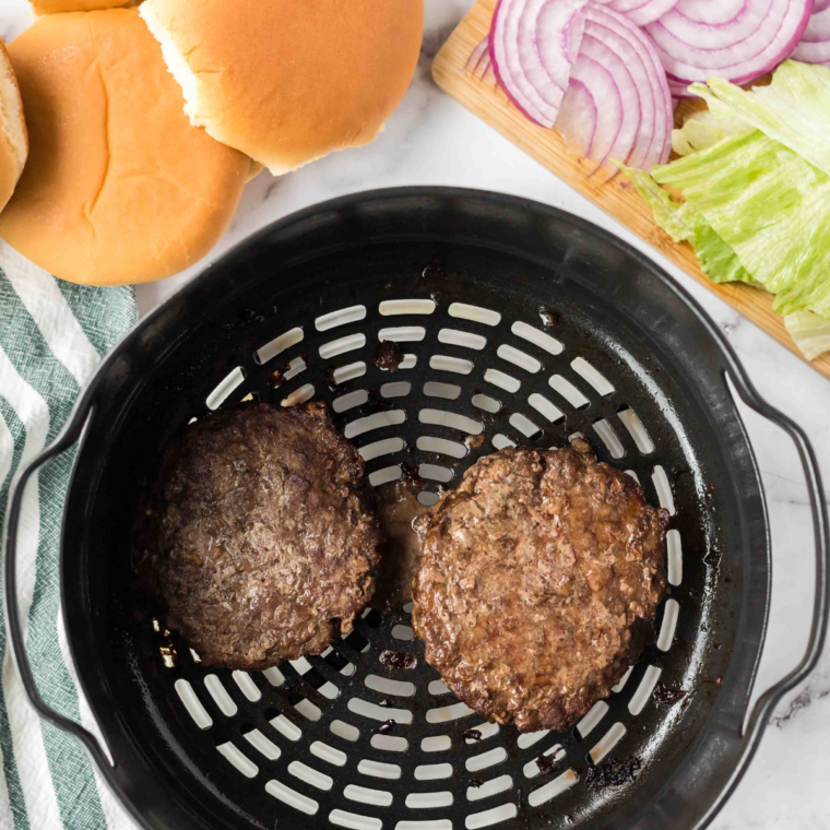 Air-frying burger patties in the Ninja Foodi for golden-brown perfection.