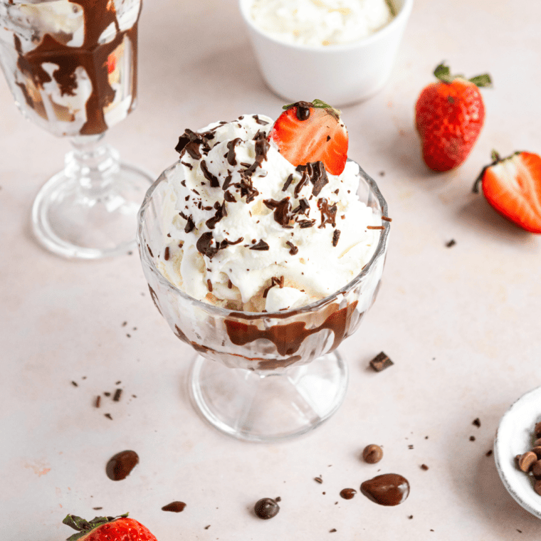 Air Fryer Blondie Brownie Cheesecake Sundae served with a side of chocolate sauce