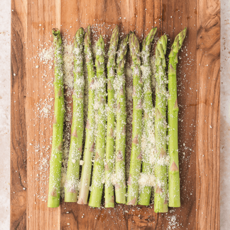 Asparagus seasoned with salt, pepper, Parmesan, and optional garlic powder.