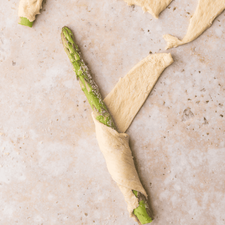Place asparagus on crescent roll dough and roll into triangles.