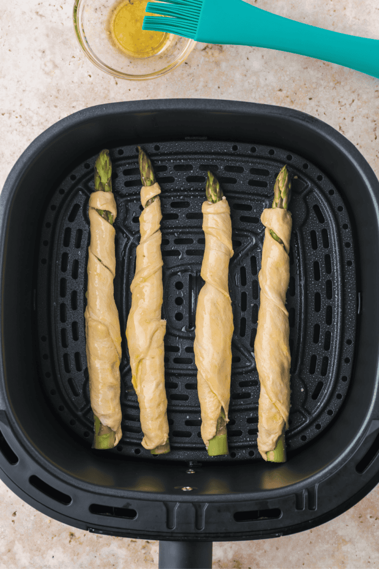 Place asparagus crescent rolls in air fryer, cook until golden.