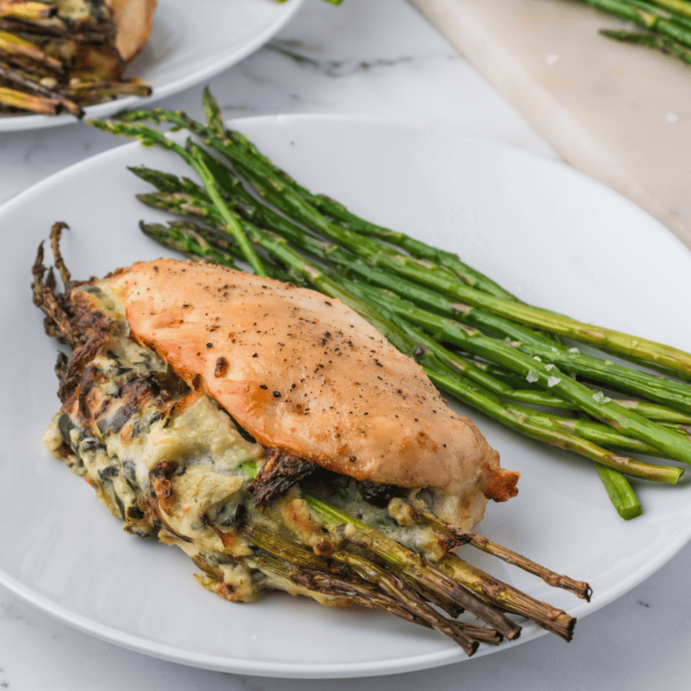 Close-up of juicy air fryer stuffed chicken breast oozing melted spinach artichoke dip