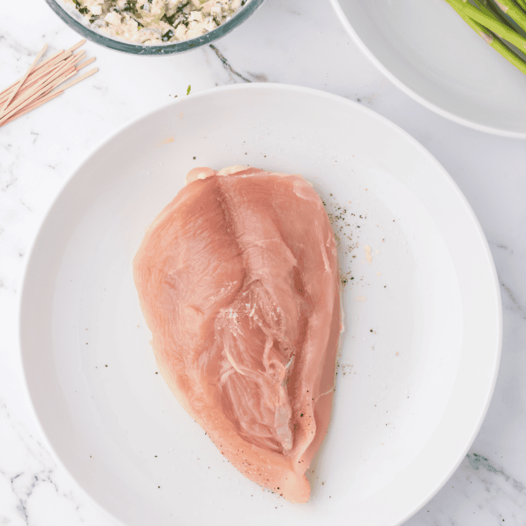 Overhead view of stuffed chicken breasts ready to go into the air fryer basket