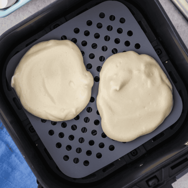 Close-up of a slice of Air Fryer Cloud Bread, in the air fryer basket.