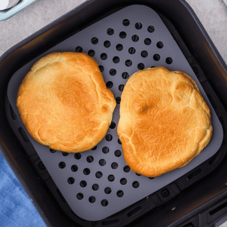 Low-carb Air Fryer Cloud Bread on parchment paper, fresh and ready to serve.